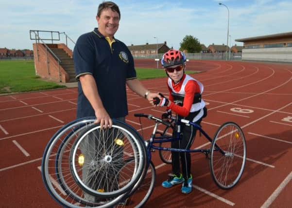 President of the Rotary Club of Sleaford, Alan Thomas, with Metheringham schoolboy Thomas Talbot, 12 who recently returned from the CPISRA European Racerunning Championships held in Denmark winning four gold medals in track events. EMN-160829-114118001