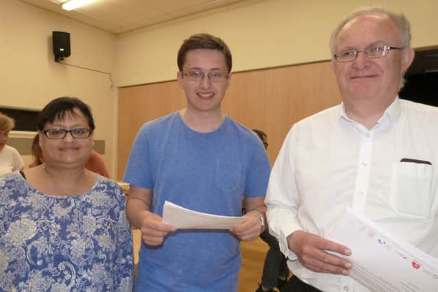 Charlie Robinson celebrates with his with mum and dad. Charlie is going to Franklin College to study law, geography, government and politics.  (Lin) EMN-160825-160002001