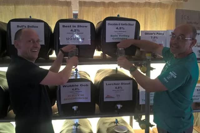 Organisers Tim Verdon and Tim Hamman serve customers at the Beer Festival EMN-160829-093616001