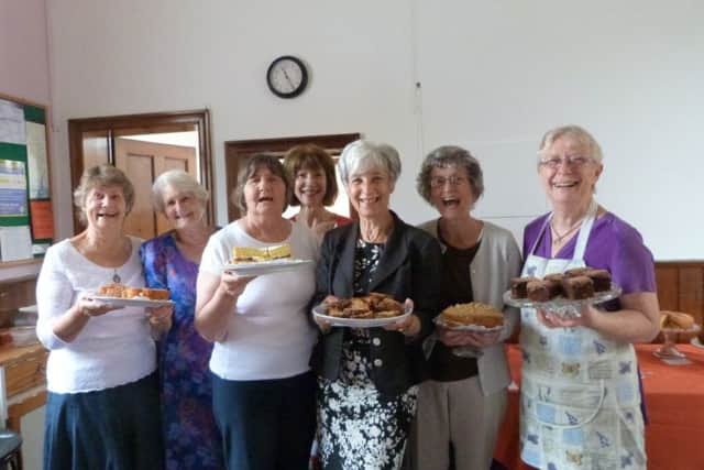Committee members, from left, Pam DeAth, Norma Moor, Trish Smith, Jill Grant, Secretary Lesley Alderson, Jean Thomas and President Midge Thomas all holding the delicious home-made cakes at the Nettleton & Moortown WI coffee morning. (Lin) EMN-160831-093745001