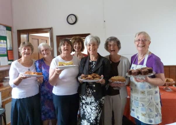 Committee members, from left, Pam DeAth, Norma Moor, Trish Smith, Jill Grant, Secretary Lesley Alderson, Jean Thomas and President Midge Thomas all holding the delicious home-made cakes at the Nettleton & Moortown WI coffee morning.  (Lin) EMN-160831-093745001