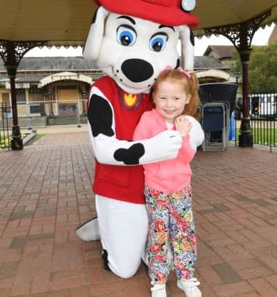 Olivia Hall 6 with Dreams and Wishes mascott. at the family fun day with teddy bears picnic at Tower Gardens, Skegness. ANL-160829-160222001