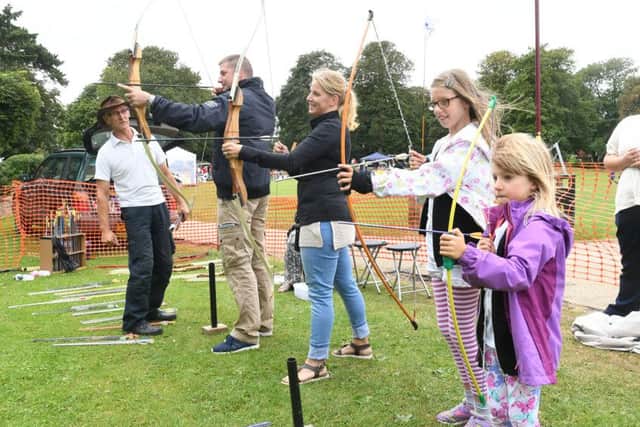 Steve Robinson of Acorn Archers, Skegness, with Simon Keeton, Rachel Keeton, Jessica Keeton, 11, and Jayda Keeton, 5, at the family fun day with teddy bears picnic at Tower Gardens, Skegness.. ANL-160829-160251001