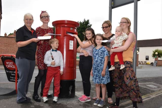 Josie Exton Sub Postmistress, left, joining mums and children to be first to drop letters in the new box EMN-160830-063836001