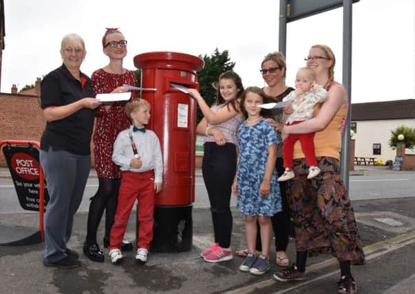 Josie Exton Sub Postmistress, left, joining mums and children to be first to drop letters in the new box EMN-160830-063836001