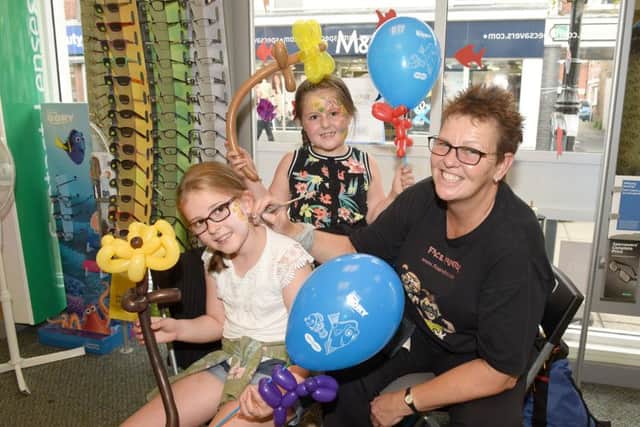 Under the Sea themed activities at Specsavers. Grace Short and Rose Short, of Sleaford, with face painter and balloon modeller Flo Dunton. EMN-160109-092938001