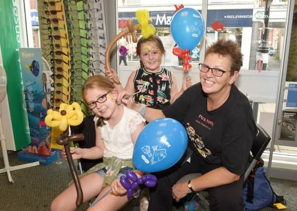 Under the Sea themed activities at Specsavers. Grace Short and Rose Short, of Sleaford, with face painter and balloon modeller Flo Dunton. EMN-160109-092938001