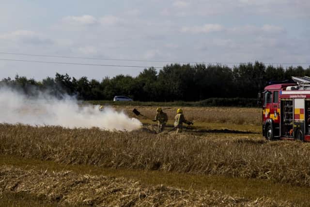 Fireifghters using beaters to stop flames spreading. Photo: Colin Brittain. EMN-160831-133540001