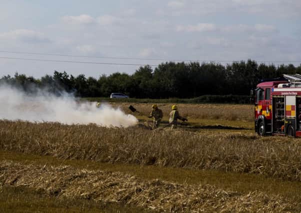 Fireifghters using beaters to stop flames spreading. Photo: Colin Brittain. EMN-160831-133540001