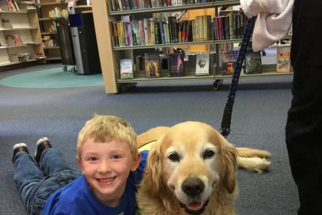 William Lord (7), from Louth, with Angus the reading dog, part of Therapy Dogs Nationwide.