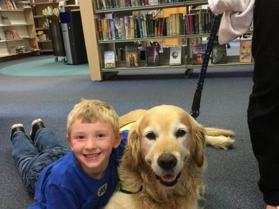 William Lord (7), from Louth, with Angus the reading dog, part of Therapy Dogs Nationwide.