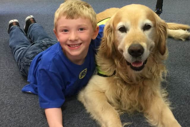 William Lord (age 7), from Louth, with Angus the reading dog, part of Therapy Dogs Nationwide.