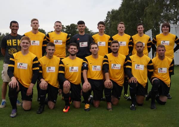 Market Rasen Town pictured in their new kit, sponsored by Hilltop Engineering and Fabrication. With manager Craig Korytnickyj on the left EMN-160109-124611002