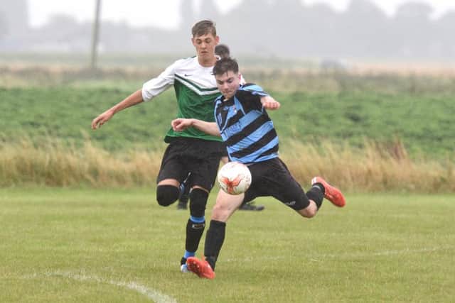 Leverton's Alex Lote and Pointon's Sean Taylor battle for the ball.