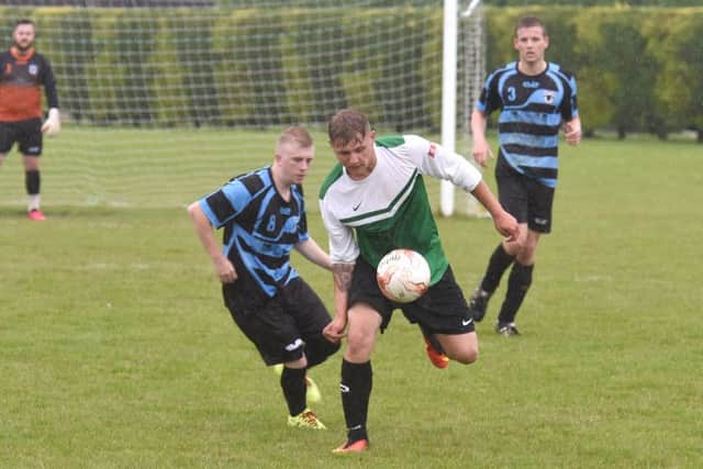 Leverton's Damian Gibbons and Danny Miller of Pointon in action.