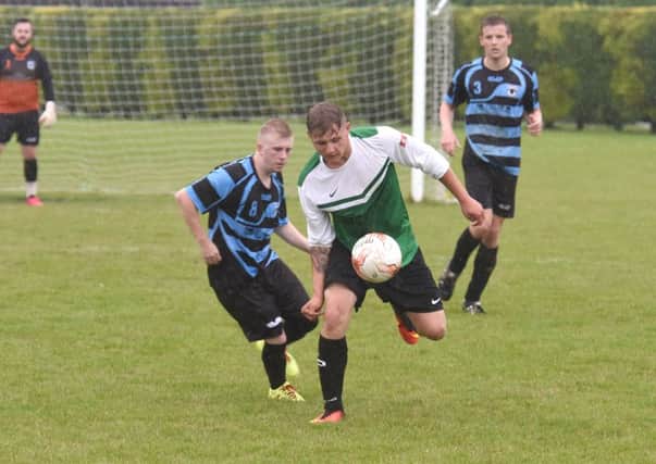 Leverton's Damian Gibbons and Danny Miller of Pointon in action.