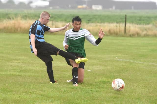 Leverton's Damian Gibbons clashes with Jack Myers of Pointon.