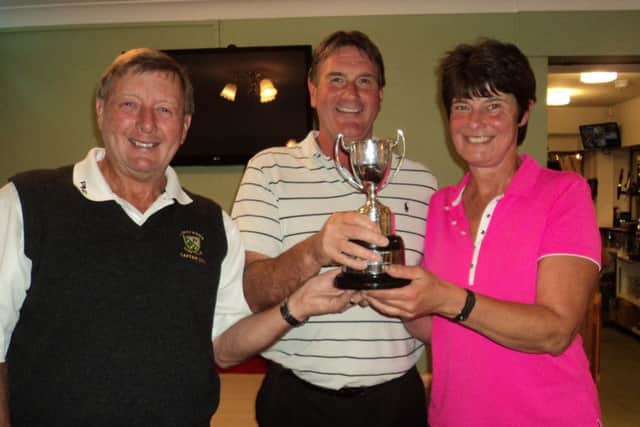 Market Rasen GC men's captain Les Brumpton presents the Ainsworth Trophy to Rob Crowe and Gill Fussey EMN-160509-124412002