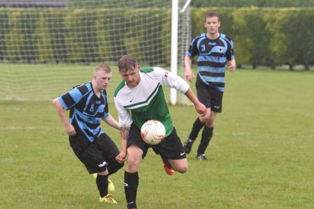 Leverton's Damian Gibbons and Danny Miller of Pointon in action.