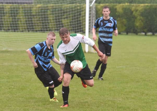 Leverton's Damian Gibbons and Danny Miller of Pointon in action.