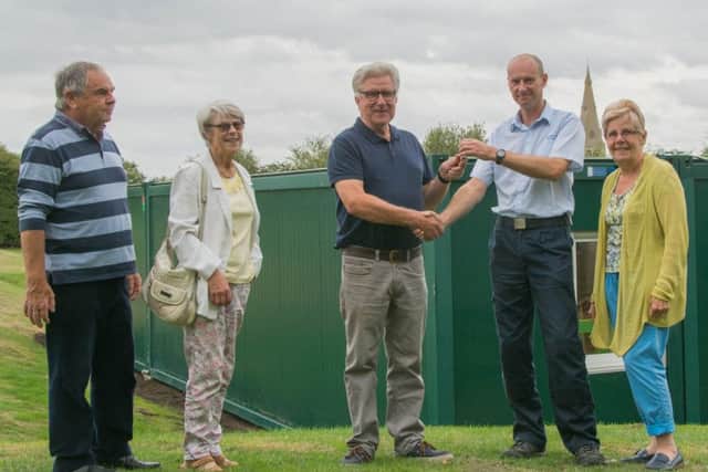 Paul Waterhouse, of Stamford Storage, handing over the keys to Parish Council chairman Jonathan Franks, with other members of the Parish Council.