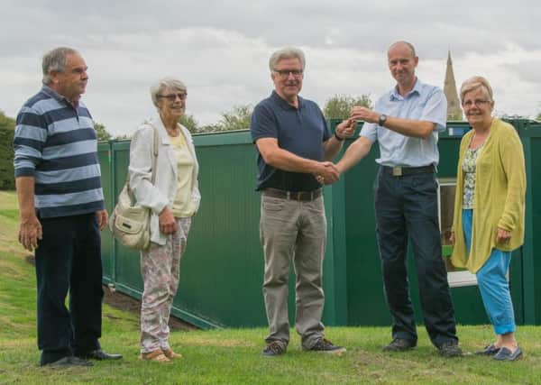 Paul Waterhouse, of Stamford Storage, handing over the keys to Parish Council chairman Jonathan Franks, with other members of the Parish Council.
