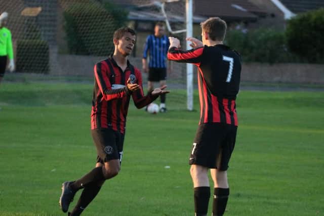 Dom Murray-Parris (left) is congratulated on one of his goals. Photo: Stephen Willmer