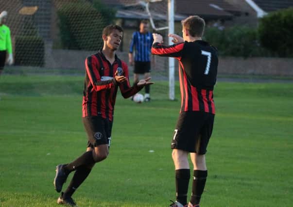 Dom Murray-Parris (left) is congratulated on one of his goals. Photo: Stephen Willmer