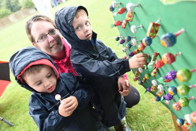 Kirsty Phillips, with Rory and William and the lollipop game at Ancaster Village Show. EMN-160709-094308001