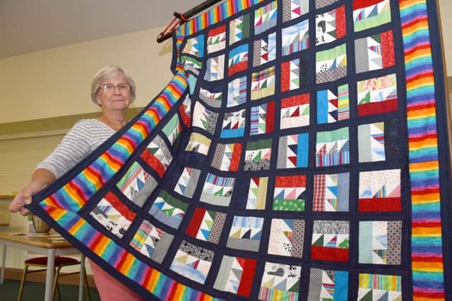 Cliffside Villages Garden and Produce Show at Wellingore. Charlotte Ridler with a quilt made by ladies of village church, to be raffled to raise money for the Access For All project. EMN-160509-103036001
