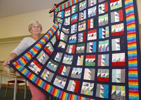 Cliffside Villages Garden and Produce Show at Wellingore. Charlotte Ridler with a quilt made by ladies of village church, to be raffled to raise money for the Access For All project. EMN-160509-103036001