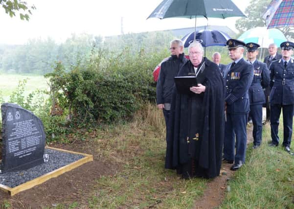 The Ven AVM Brian Lucas dedicates the new memorial close to the Lancaster crash site on Love Lane in Caythorpe watched by RAF  personnel and relatives. EMN-161209-133645001