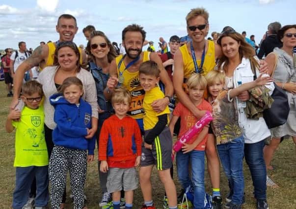 Brigg runner Mark Morris, centre, with fellow runners , family and friends at the end of the Great North Run EMN-160914-145728001
