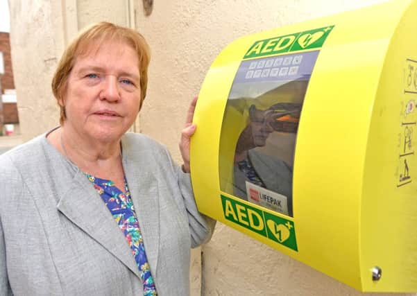 Town mayor Coun Angela Birchall with a defibrillator