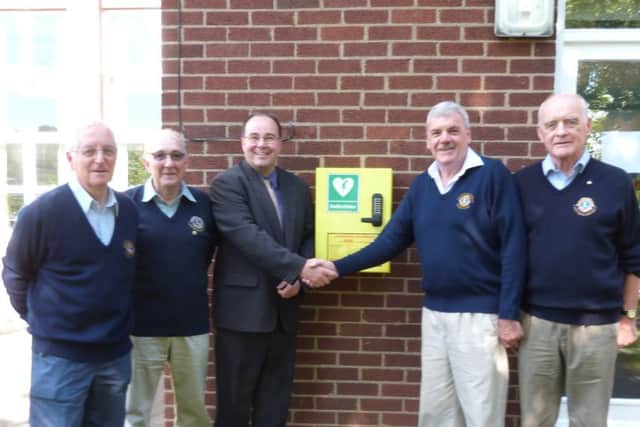 Lions (left) Bob Oxley, Eric Pickering, Terry Box and Stuart Roach, with Kelsey head teacher Magnus Smedley and the new defibrillator . (Lin) EMN-160914-141112001