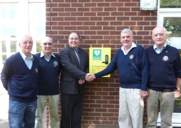 Lions (left) Bob Oxley, Eric Pickering, Terry Box and Stuart Roach, with Kelsey head teacher Magnus Smedley and the new defibrillator . (Lin) EMN-160914-141112001