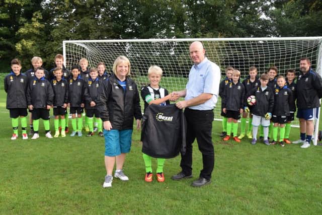 Nick from Dexel presenting the jackets to the teams captain and manager Karen Bett at Rase Park EMN-160915-114450002