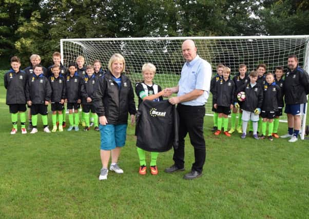 Nick from Dexel presenting the jackets to the teams captain and manager Karen Bett at Rase Park EMN-160915-114450002