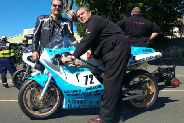 Pictured are rider Richard Lambourne and Ashley Blinds owner Paul Ashley on the Glencutchery Road warming up the RG500 ahead of the Superbike race.