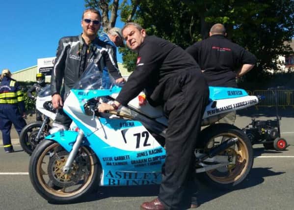 Pictured are rider Richard Lambourne and Ashley Blinds owner Paul Ashley on the Glencutchery Road warming up the RG500 ahead of the Superbike race.