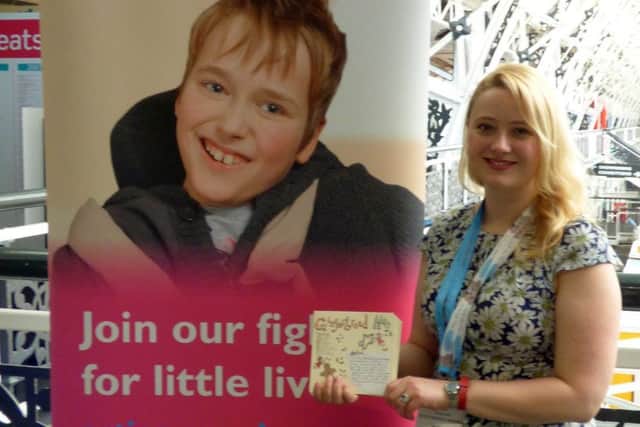 Sleaford designer Amy Cockcroft is pictured with her new christmas card design EMN-160920-115315001