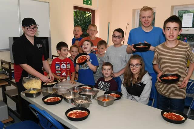 Rainbow Flyers youth club, pizza making demonstration by Little Italy. Little Italy manager Danielle Holliday youth club members. EMN-160919-182901001