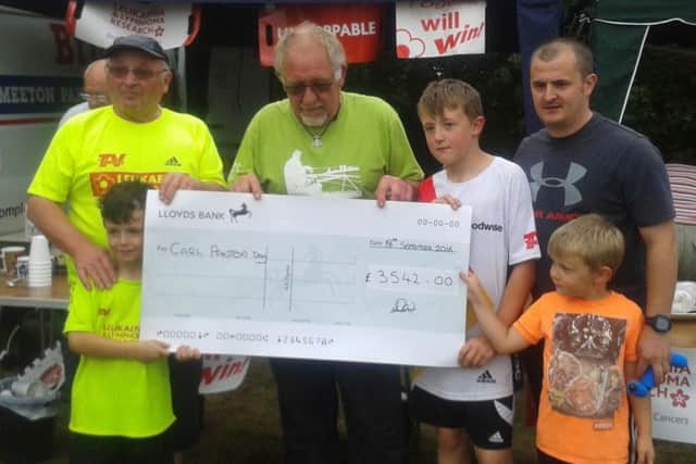 Dave Wollerton of Daves Peg presenting a cheque to Stuart Panton, father of Carl EMN-160921-144850001