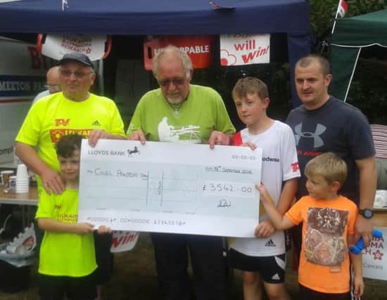 Dave Wollerton of Daves Peg presenting a cheque to Stuart Panton, father of Carl EMN-160921-144850001