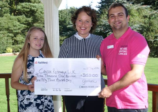 Maia Wilkinson,17, and Carolyn Vickers-Lingard,50, hands over Â£3,153 to Ben Petts, Local fundraising manager for Cancer Research UK last week at fundraising ball venue, Kenwick Park Hotel in Louth.