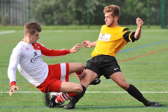 McCauley Parker slides in against Rasen goalscorer Rafael Garda.