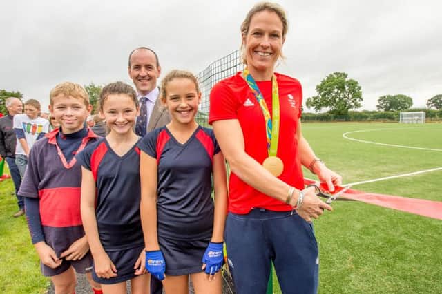 Crista Cullen cuts the tape, pictured with St Hugh's head boy Joseph Bell, head girl Ollie Henson, hockey captain India Norwood and headteacher Chris Ward. Photo: John Aron