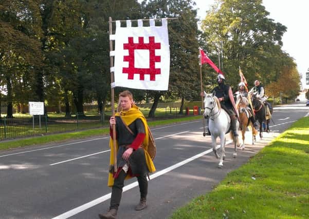 The 1066 Saxon re-enactors march into Sleaford along Boston Road. EMN-160930-140336001