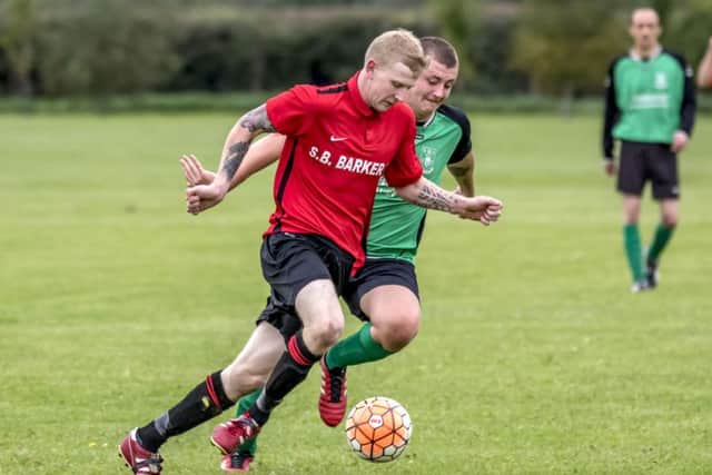 Coningsby Reserves Sean Taylor tries to get away from his Billinghay marker during Saturdays derby. Photo: Oscarpix Imaging.