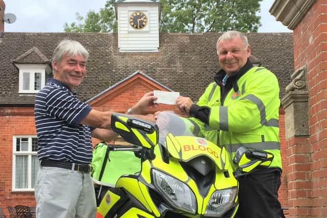Men's captain Graham Sykes hands over his £2,000 charity fundraising total to Smiler Hutson EMN-160310-105052002